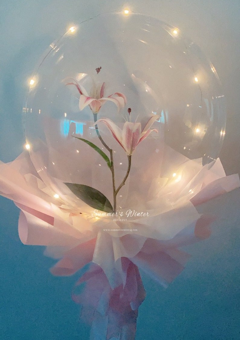 faux lilies balloon bouquet in pink wrapping paper