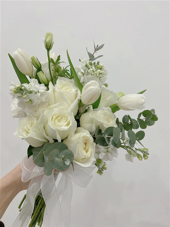 Bridal bouquet with tulips, roses, matthiola, eustoma and foliage
