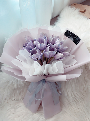 fresh purple tulips with purple wrapping paper