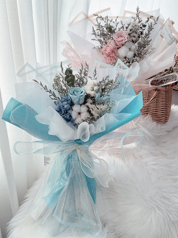 flower bouquet designed with dried rose & colourful ribbon wrapped  