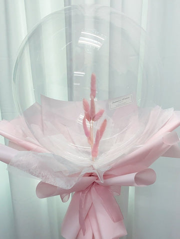 Pink Bunny Tail flower balloon bouquet in pink wrapping paper